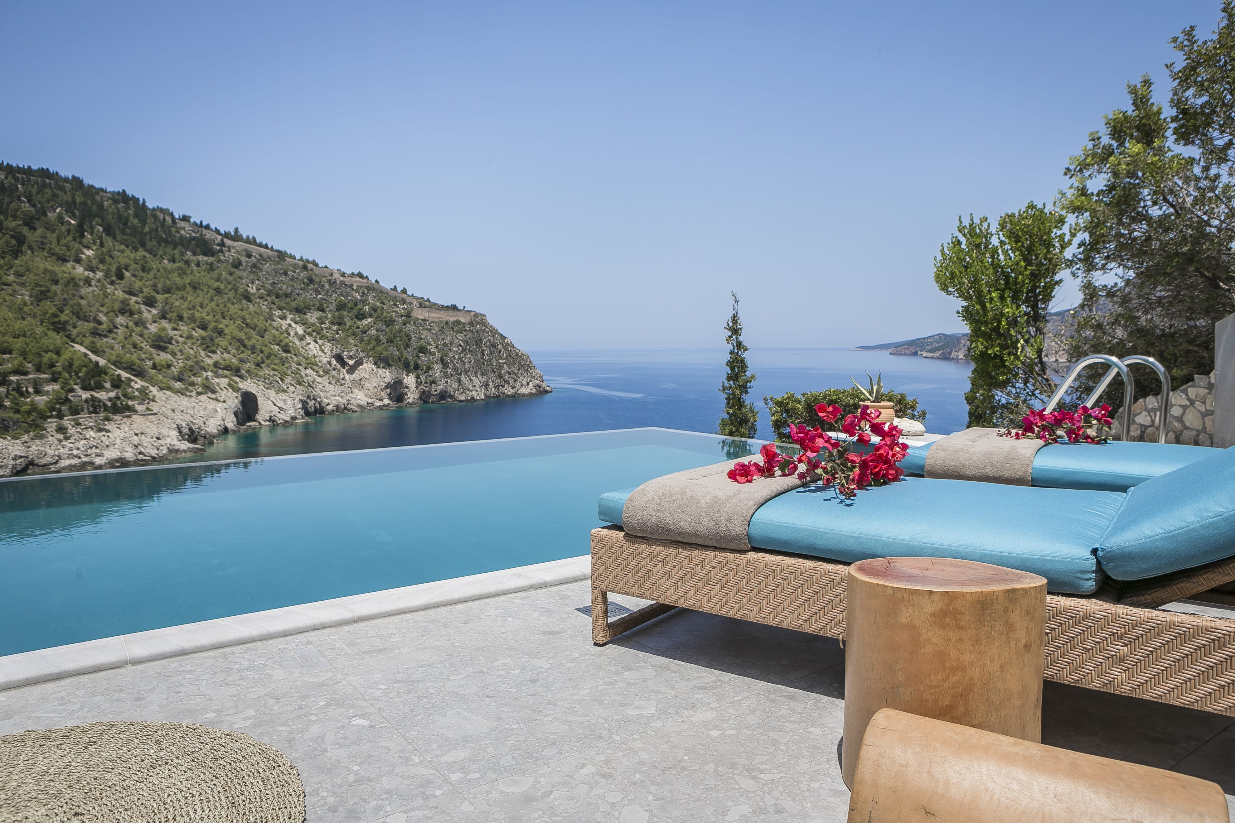 a lounge chair on a deck overlooking a body of water