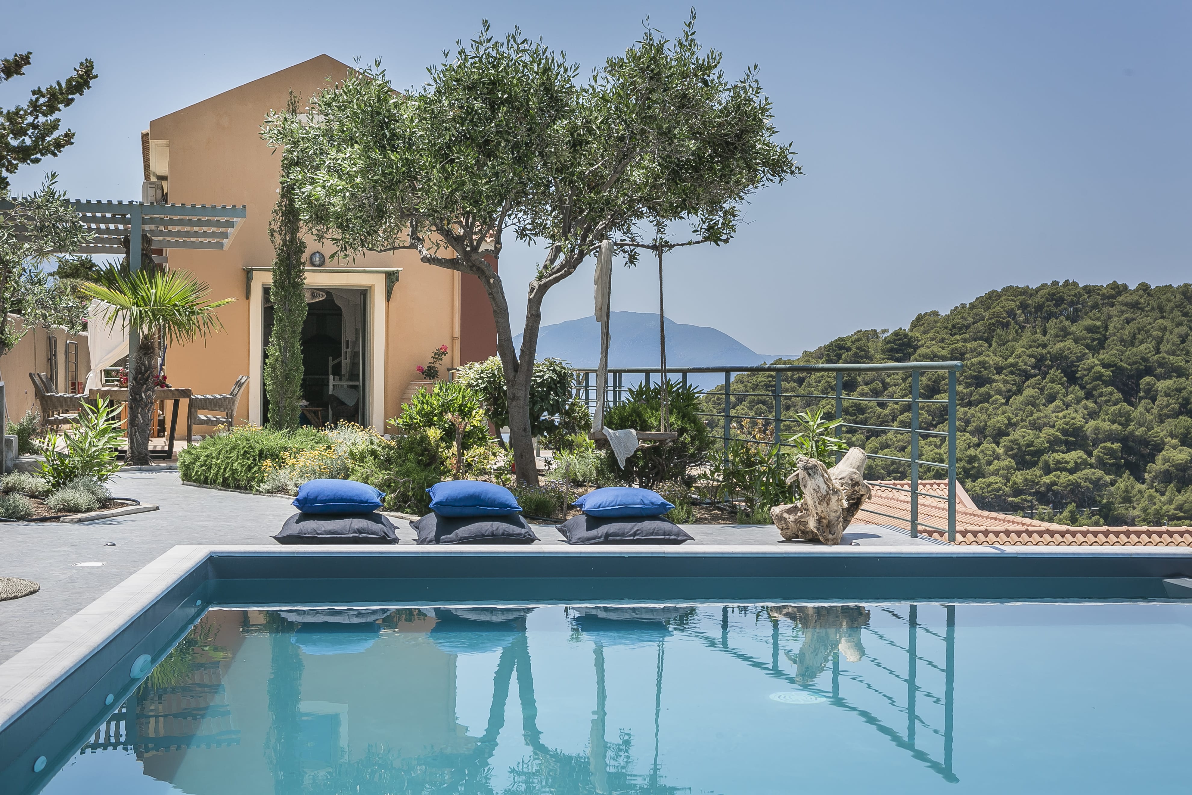 a pool with chairs and a tree