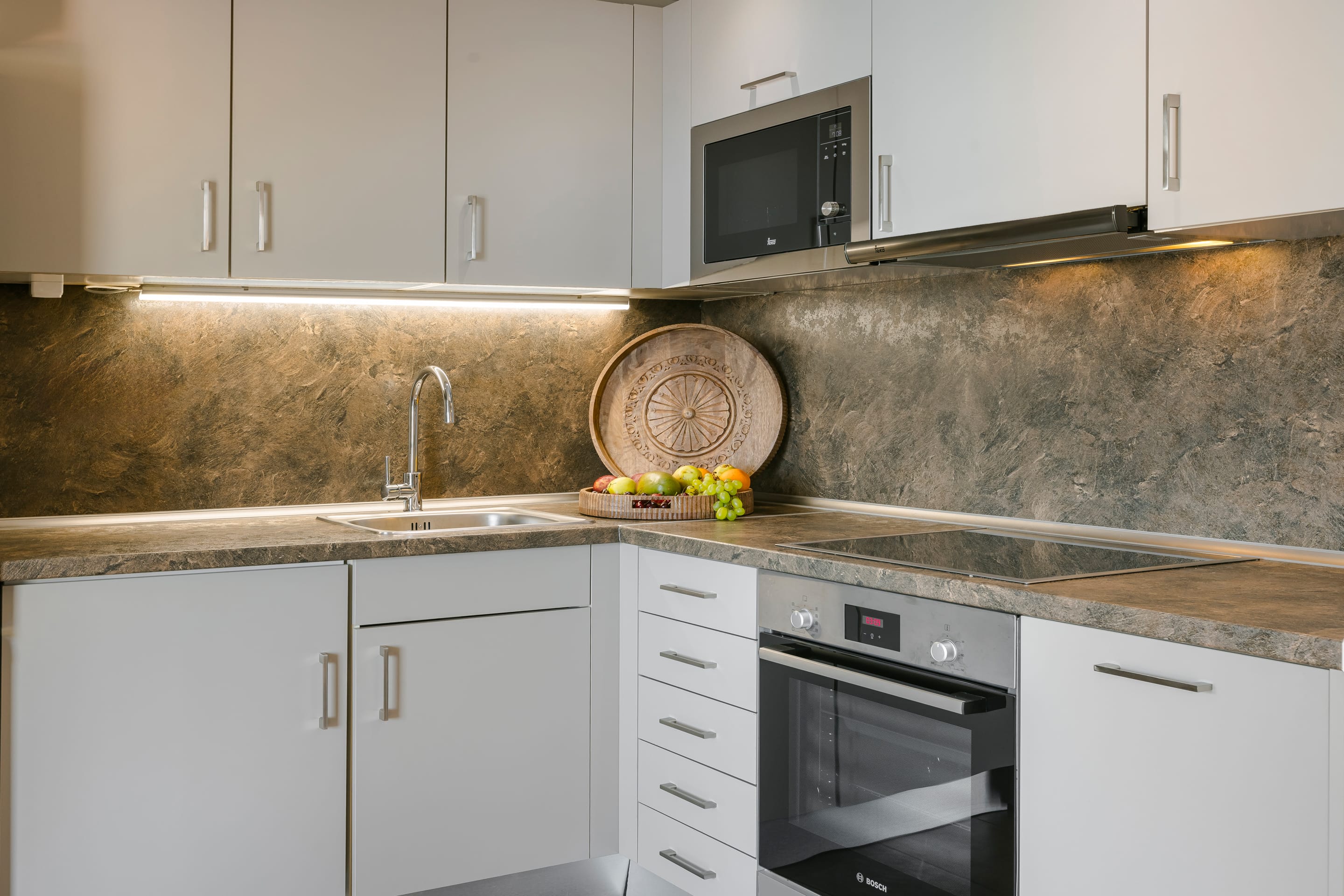 a kitchen with white cabinets