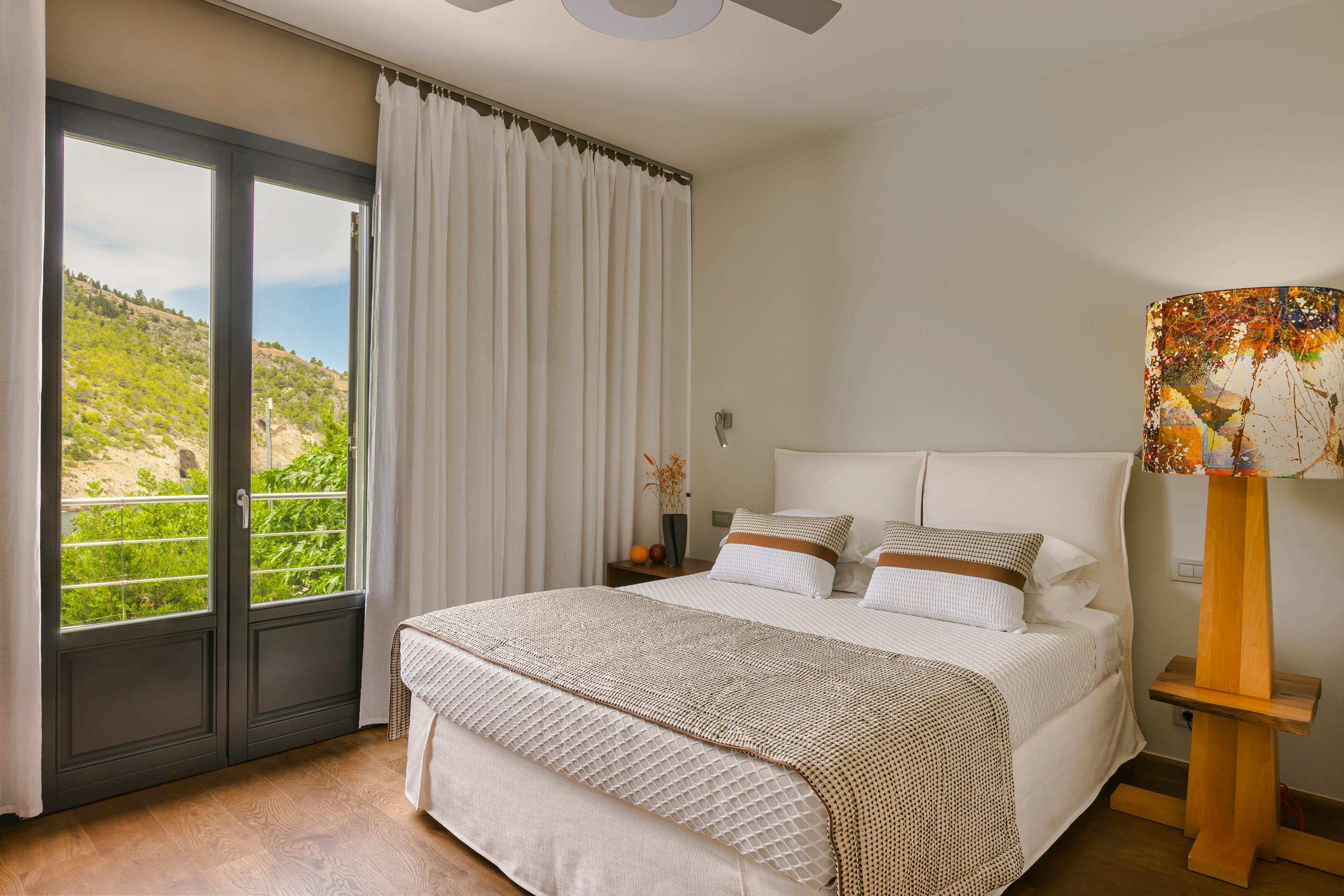 a bedroom with a large window