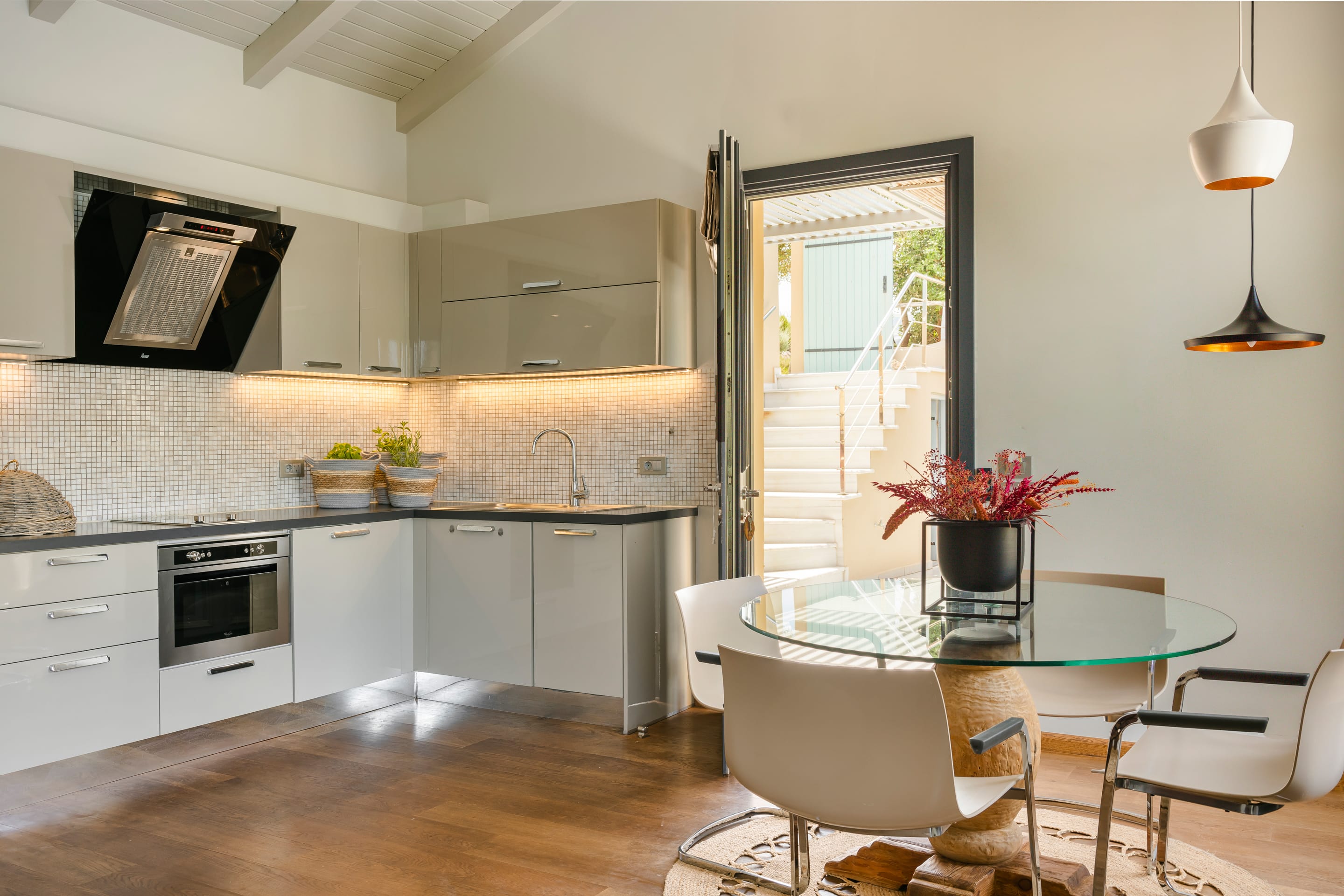 a kitchen with a table and chairs