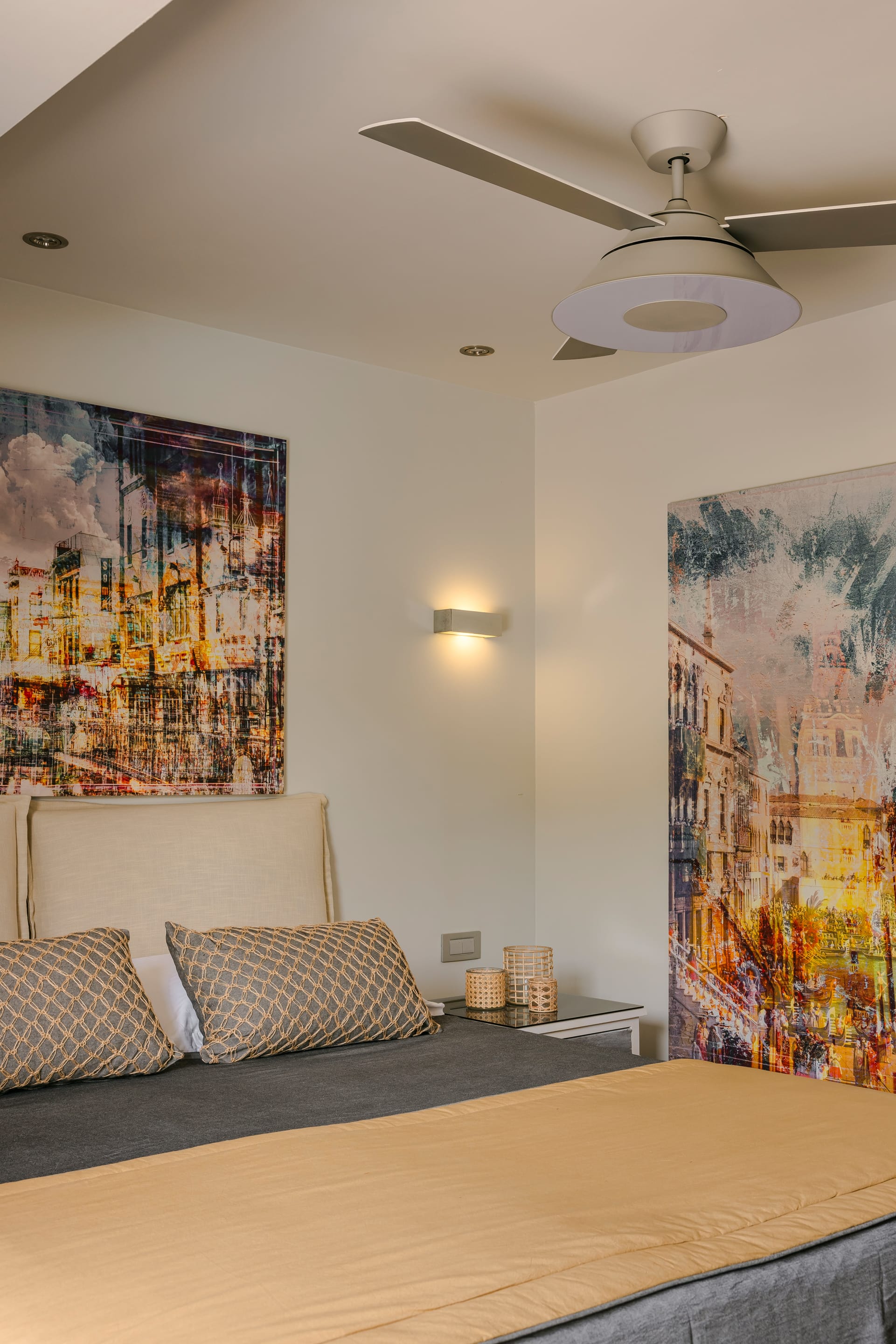 a bedroom with a ceiling fan and a bed