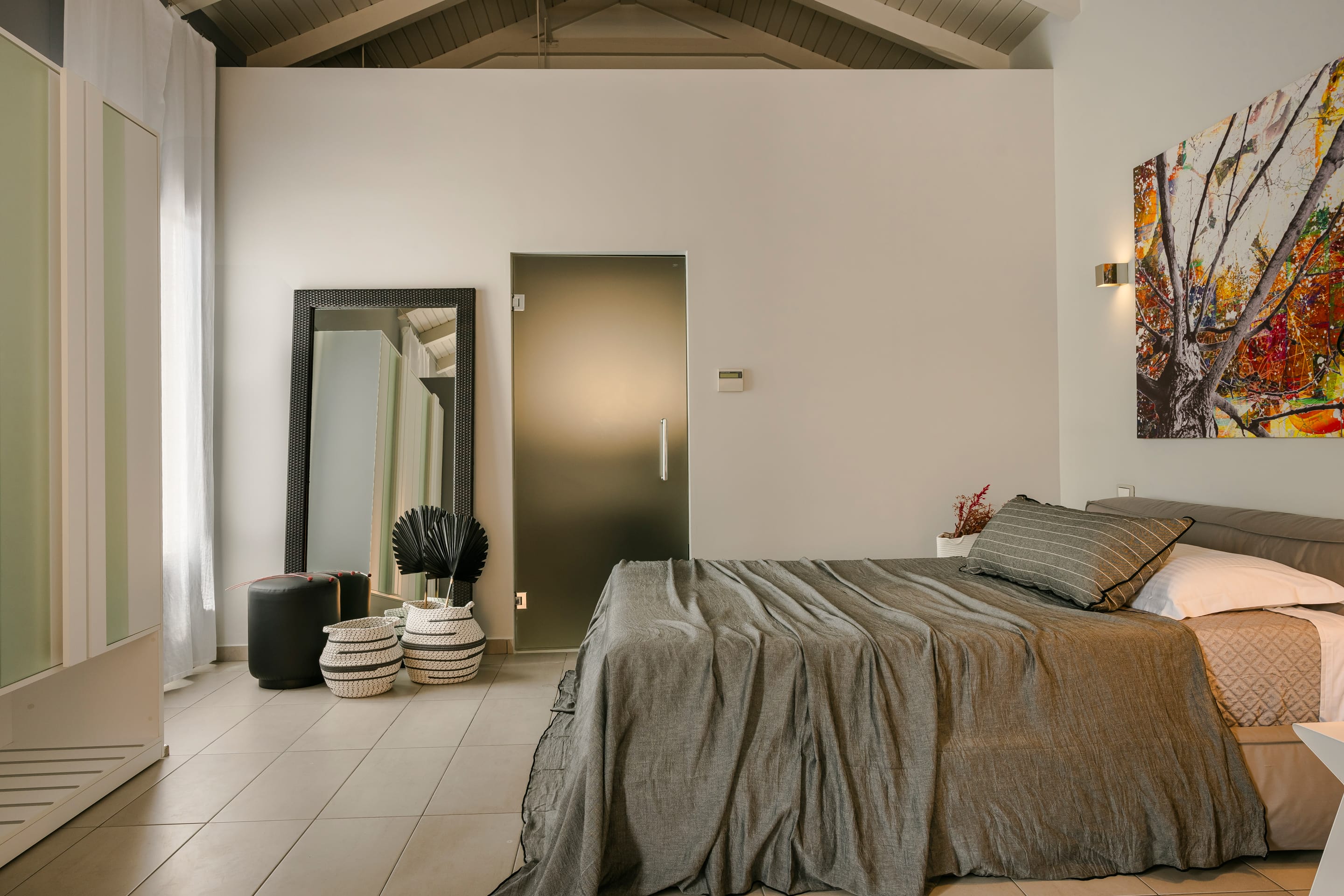 a bedroom with a large mirror