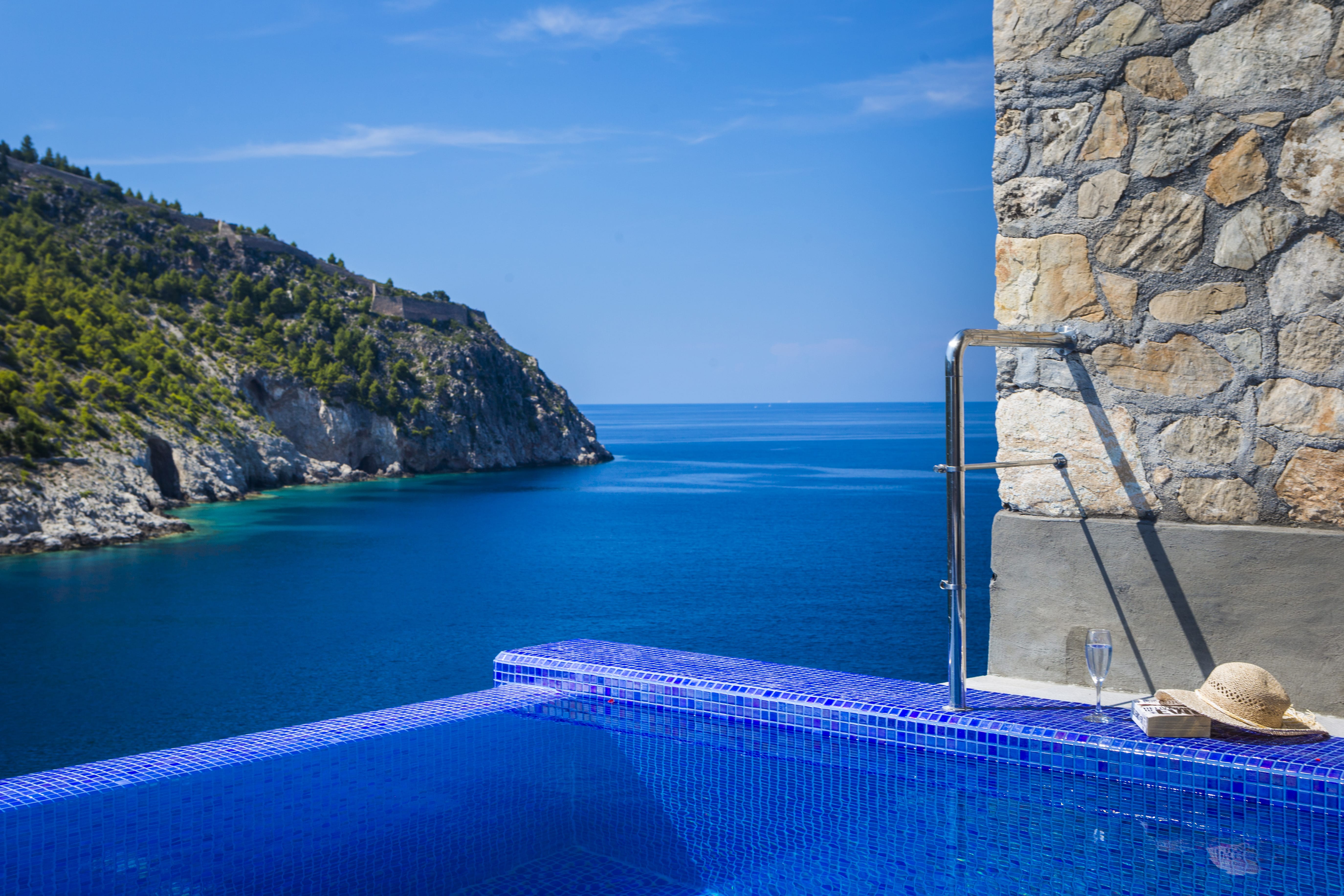 a blue pool with a staircase