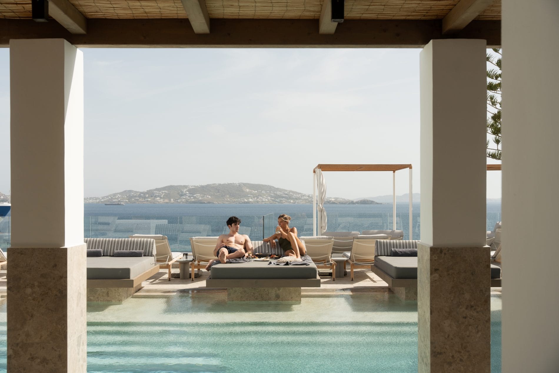 a couple sitting on a chair in a pool