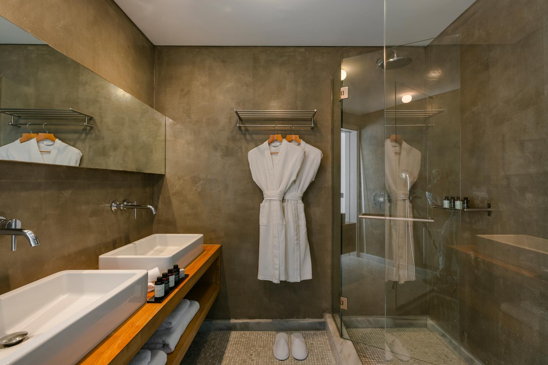 a bathroom with a shower unit and sink