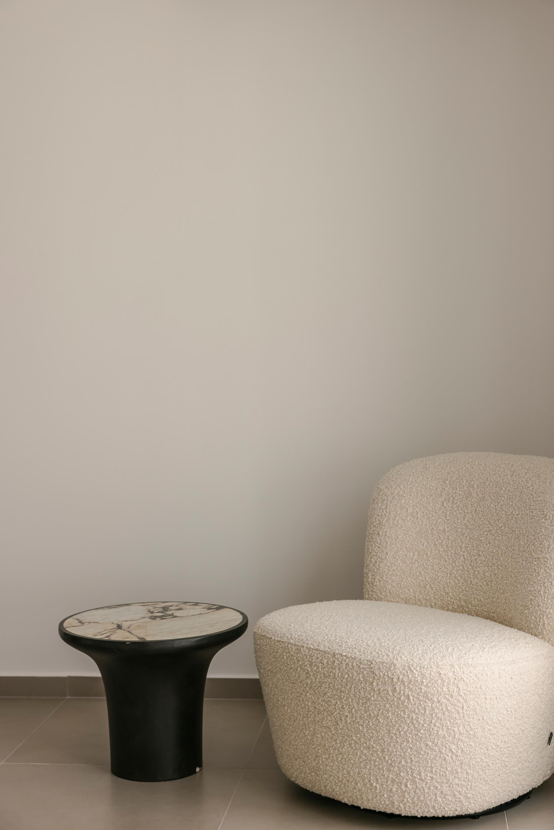 a white chair and a black coffee table