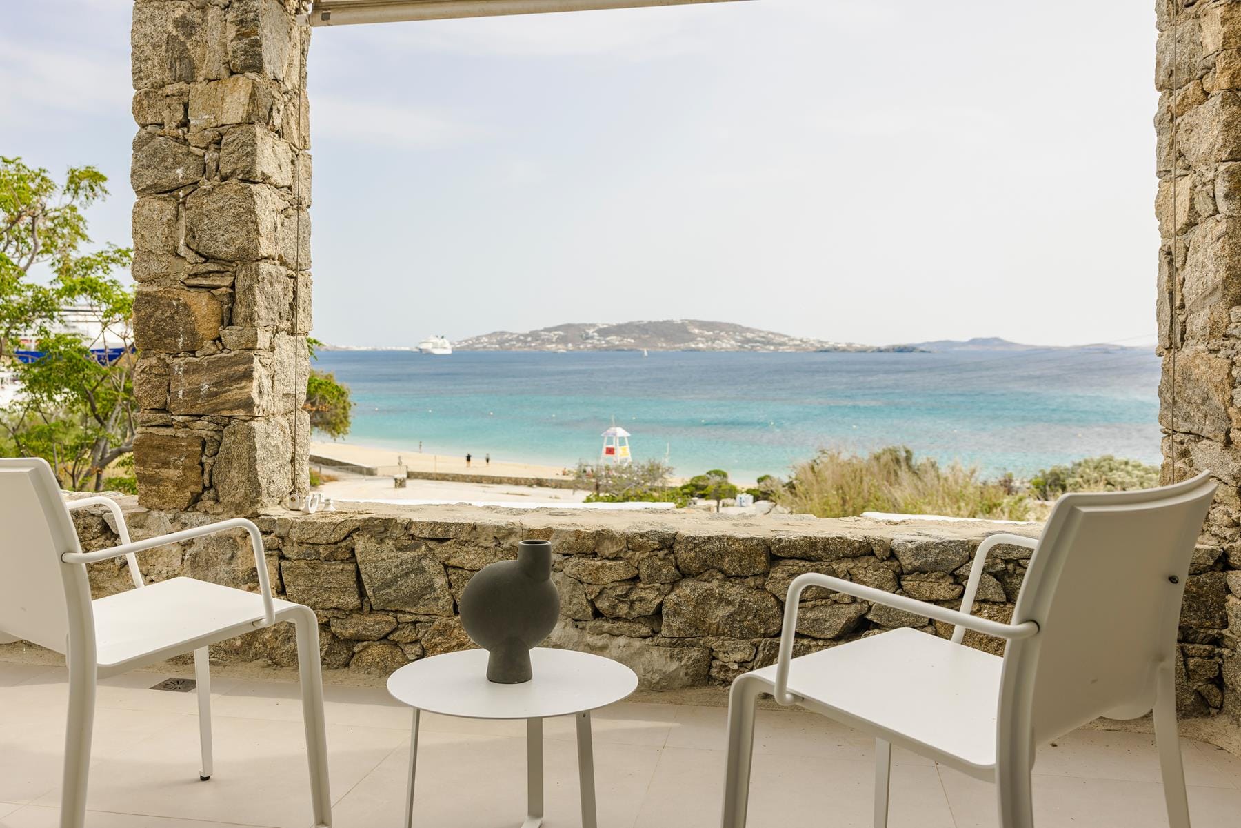 a table and chairs overlooking a beach
