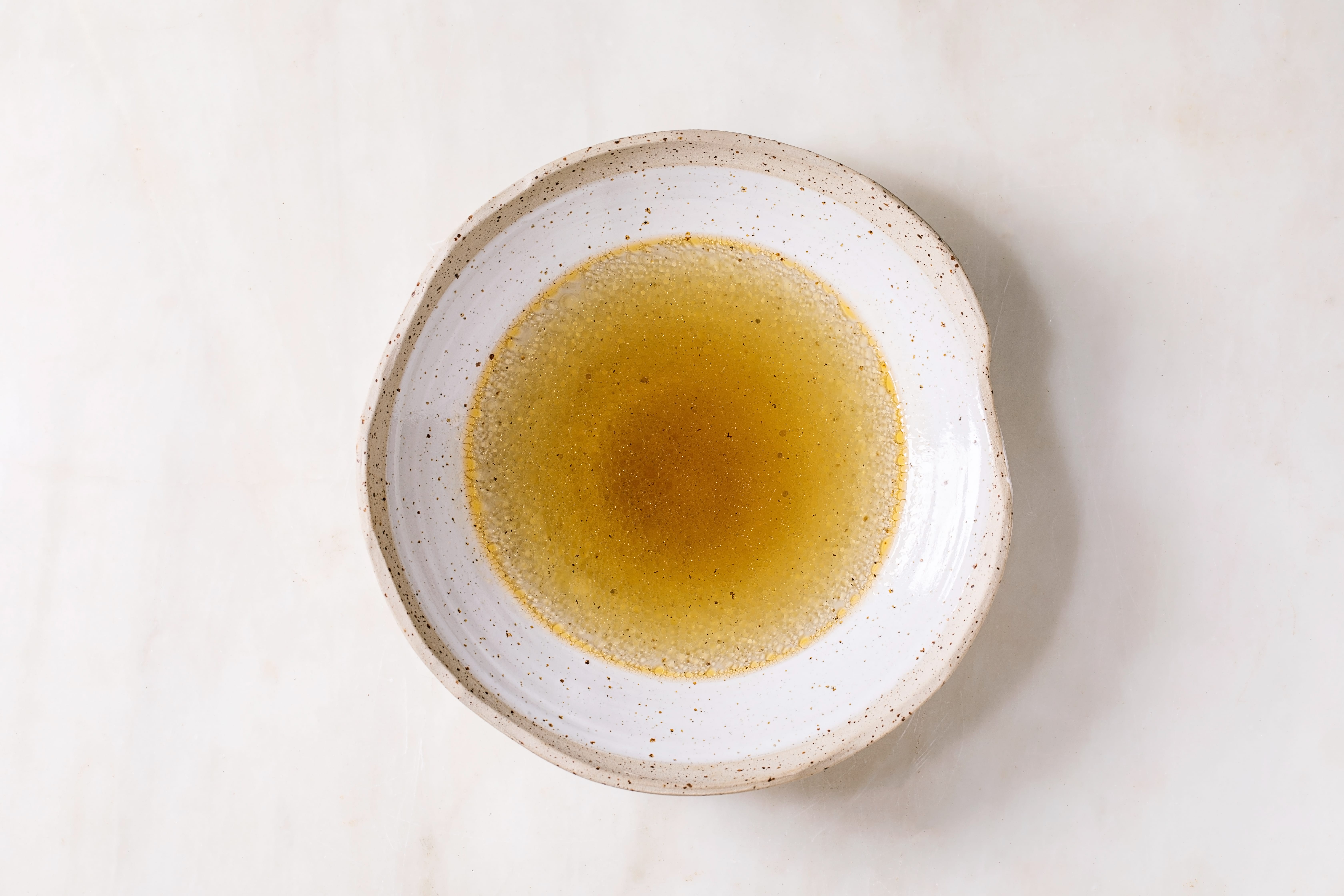 a white bowl with a yellow substance