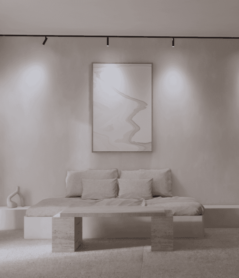 a white bed with a painting on the wall