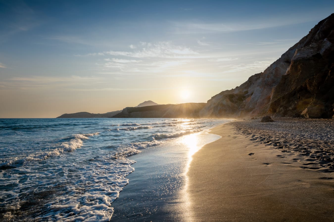 a beach with waves and rocks