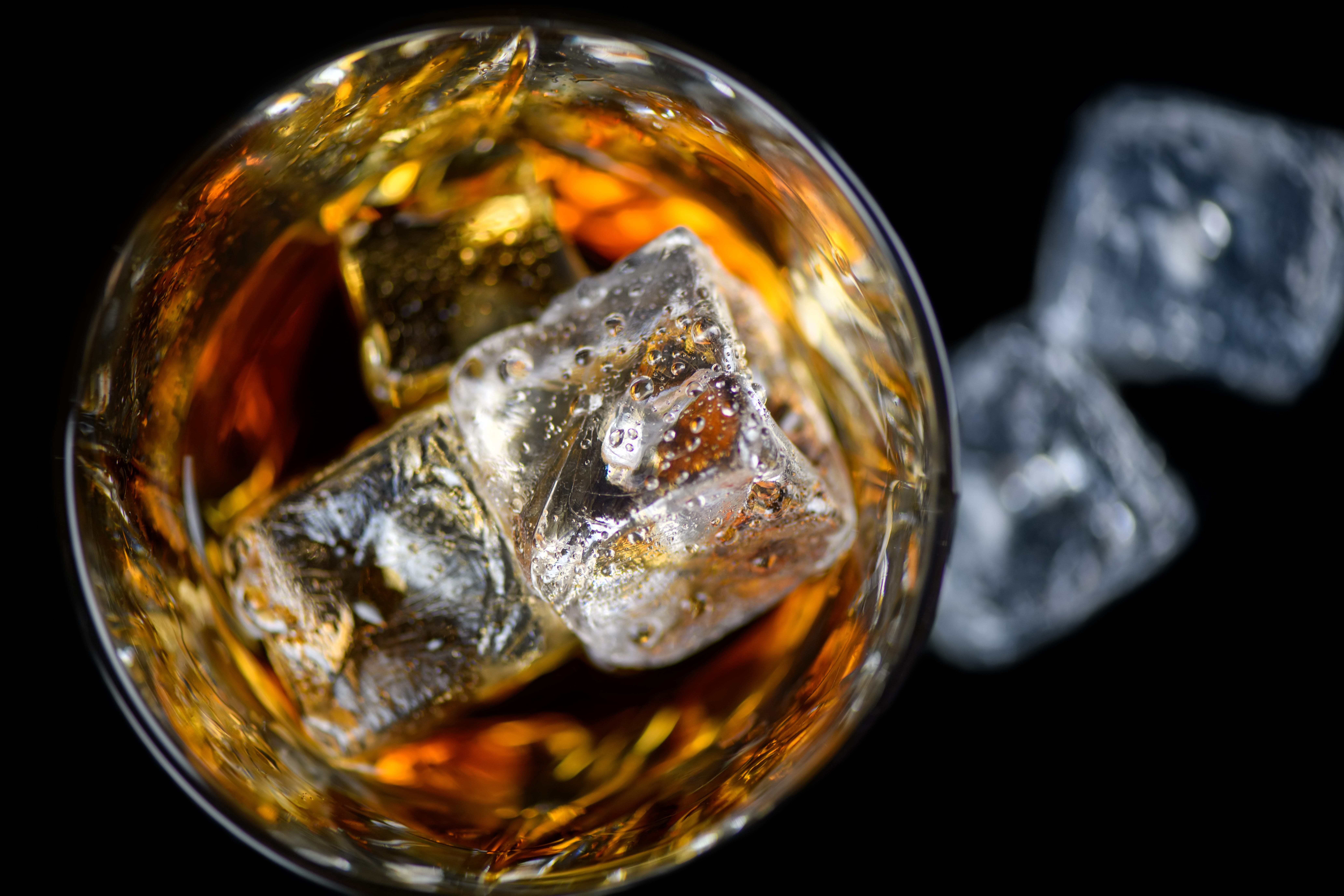 a glass of liquid with a piece of paper in the background
