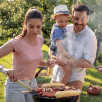 a family cooking outside