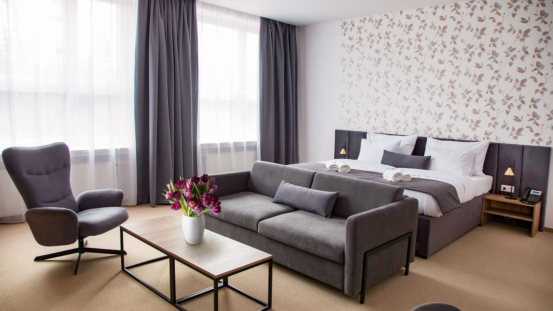 a room with a couch and chairs