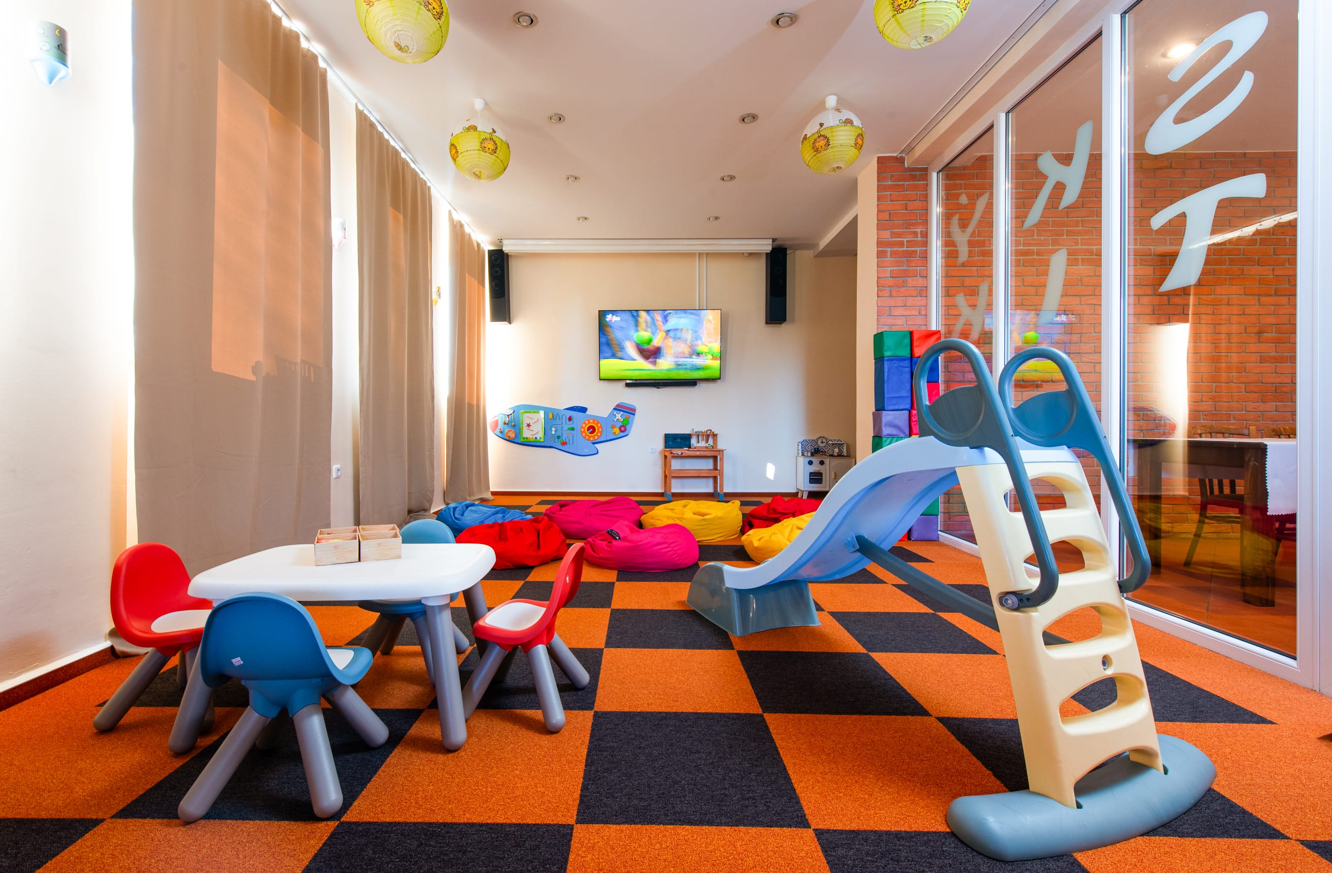 a room with a slide and chairs