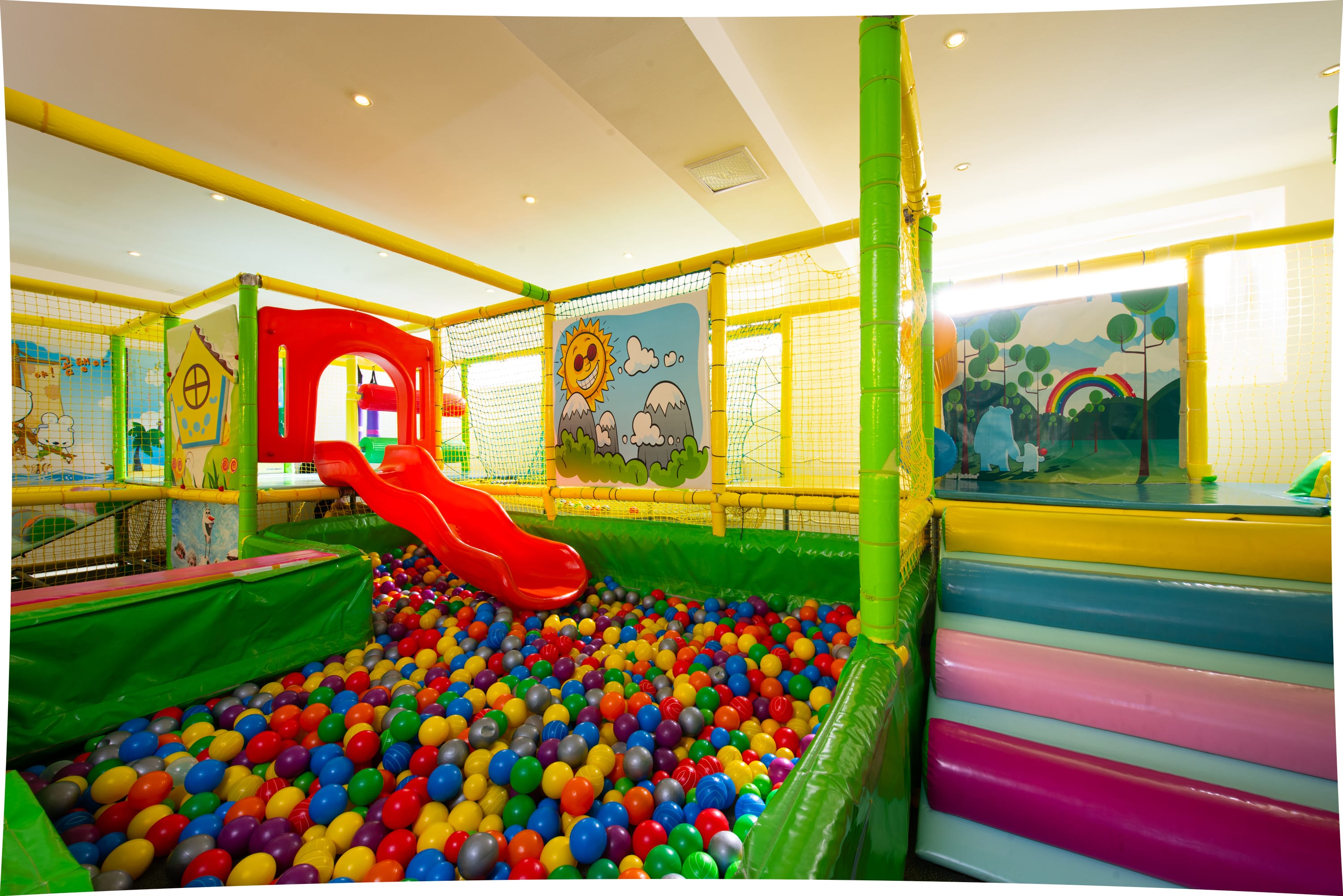 a child's toy in a room with colorful balls