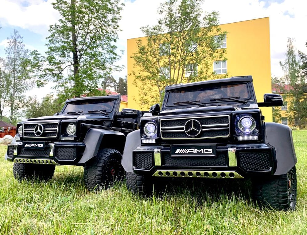 a black truck parked in a grassy field