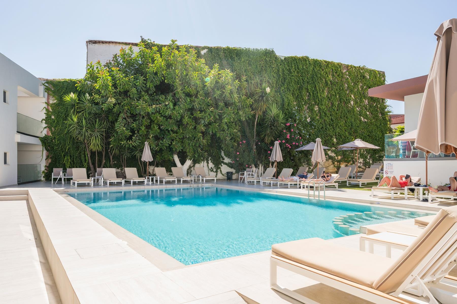 a pool with chairs and umbrellas