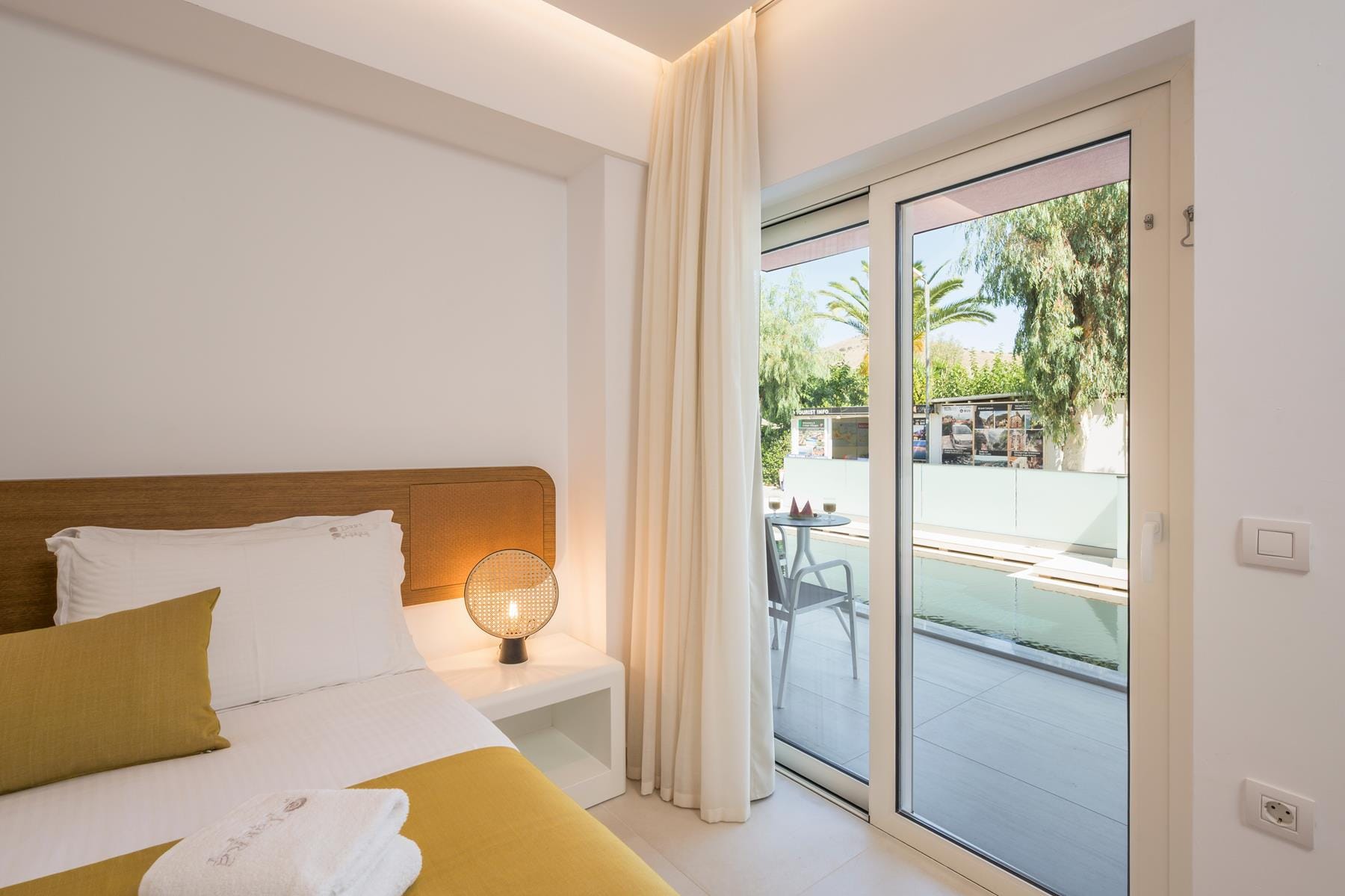 a bedroom with a large glass door