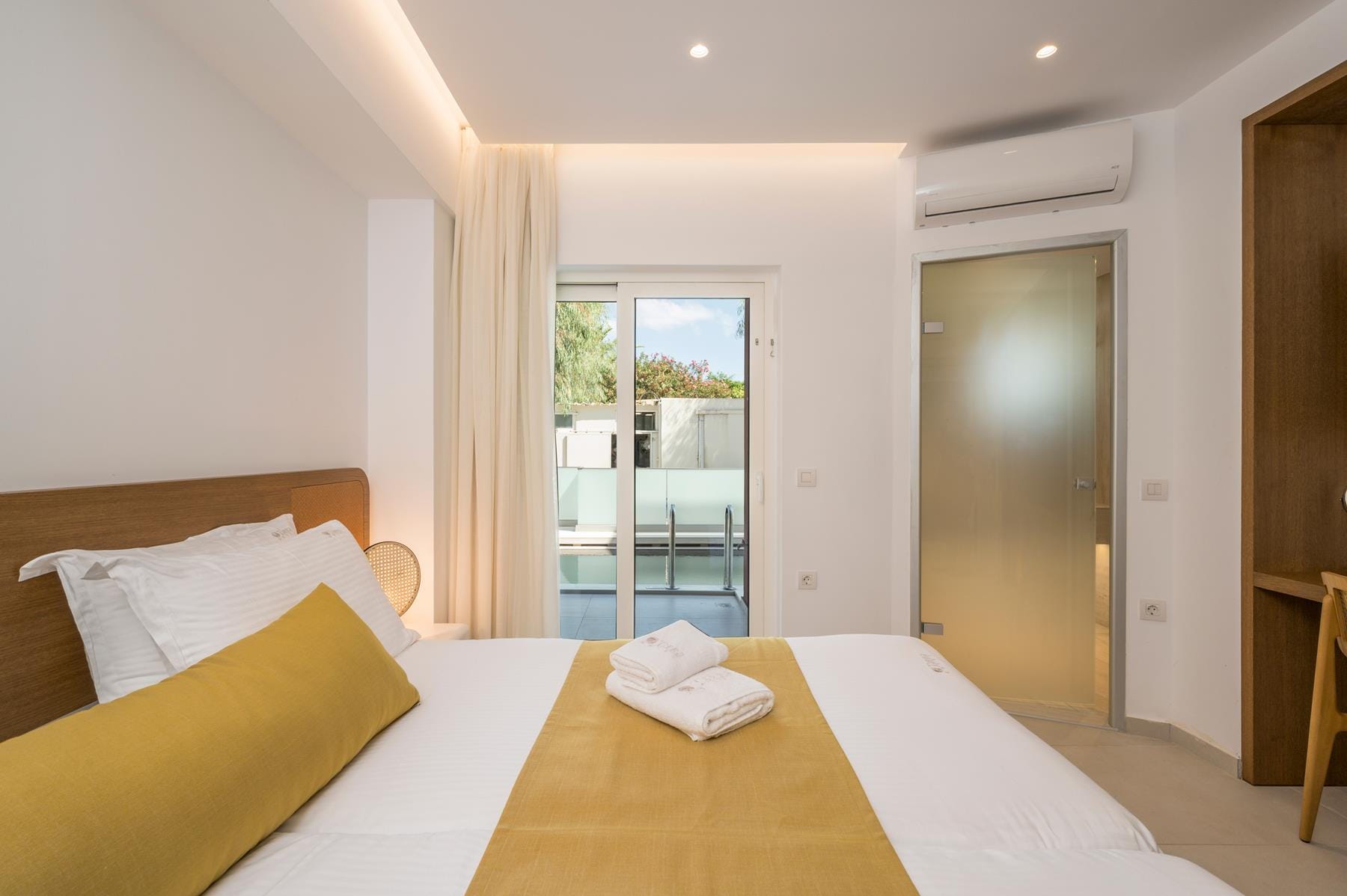 a bedroom with a large glass door