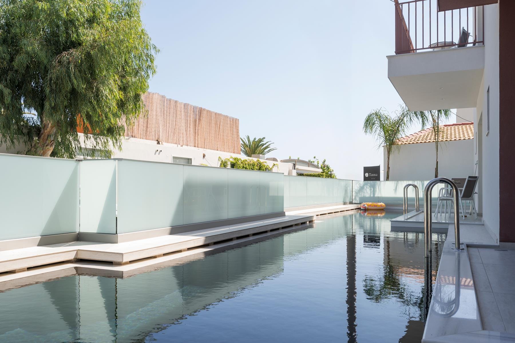 a pool with a deck and chairs