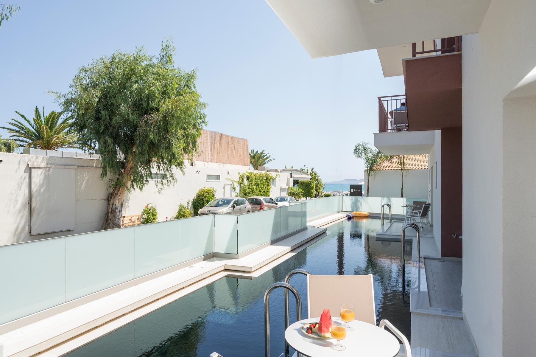 a balcony with a table and chairs