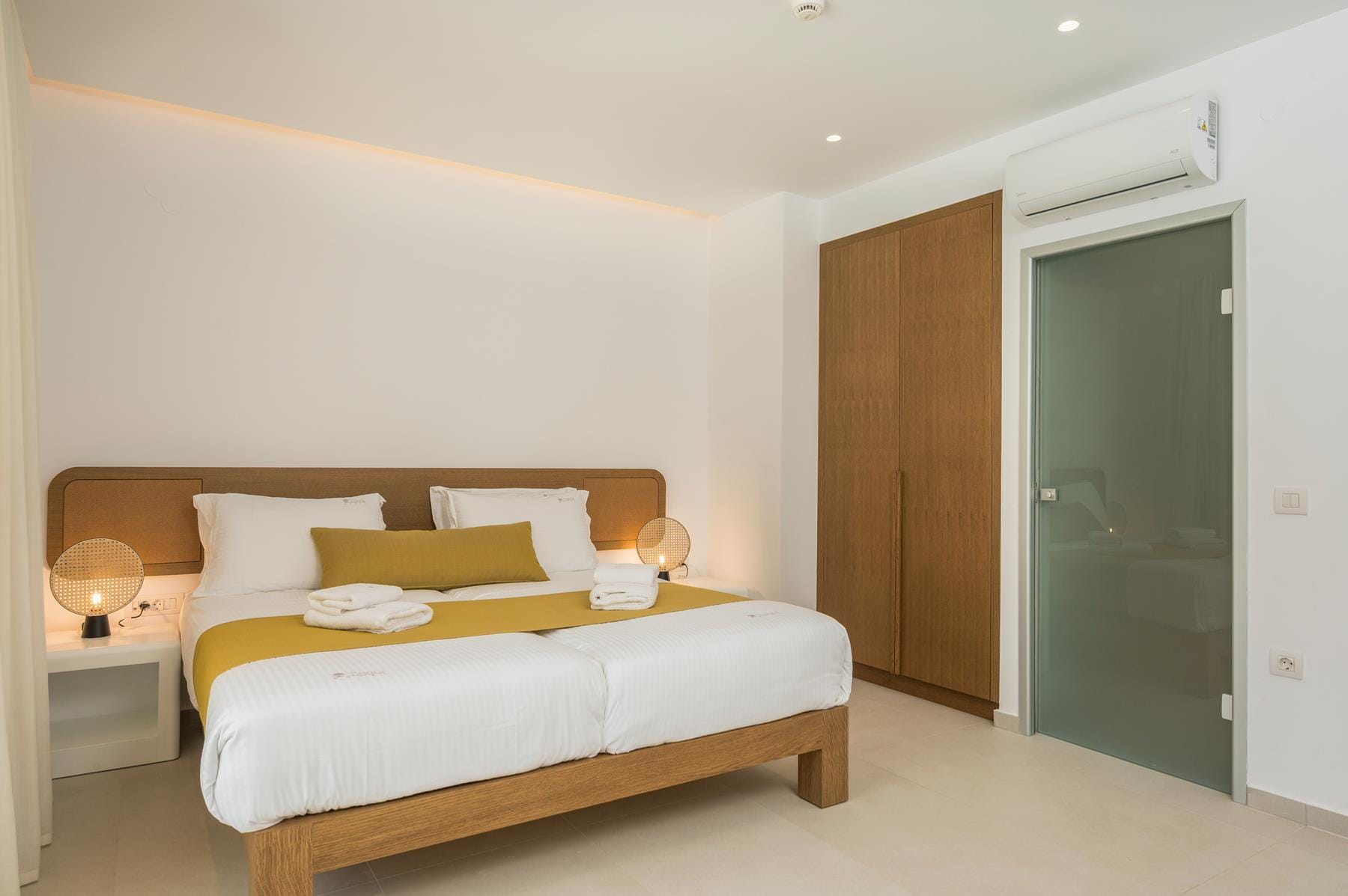 a bedroom with a bed and a lamp