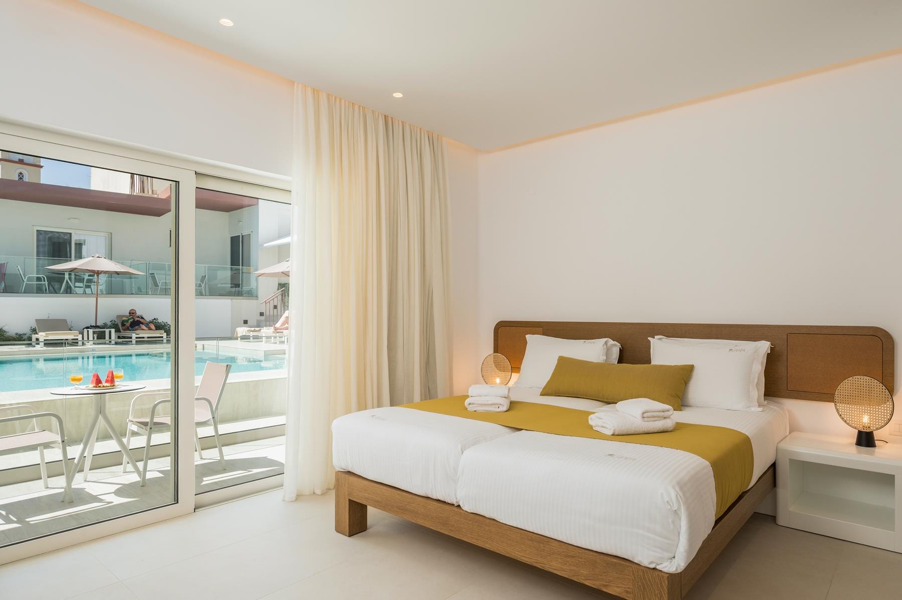 a bedroom with a large glass door