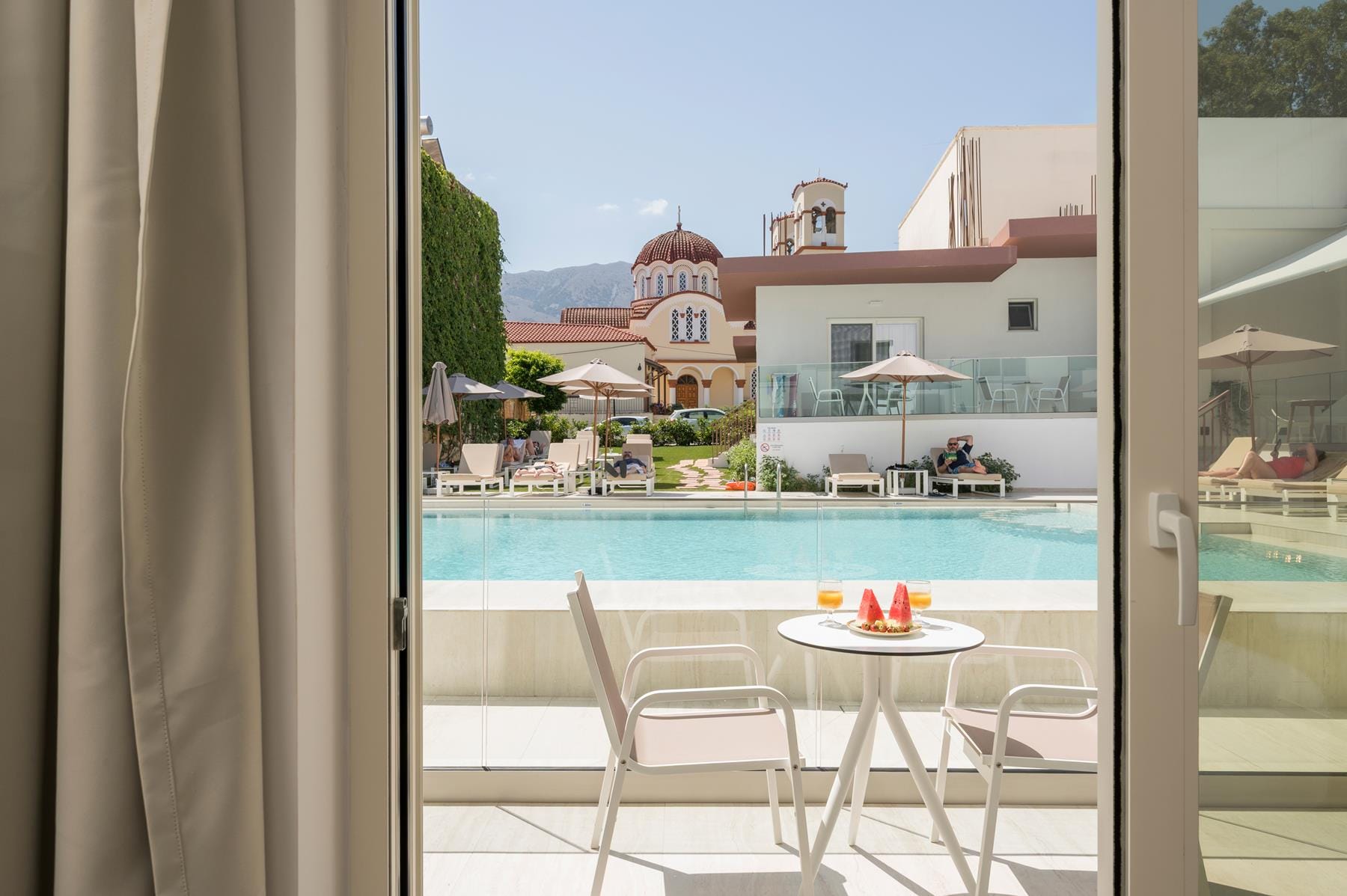 a pool and chairs next to a window
