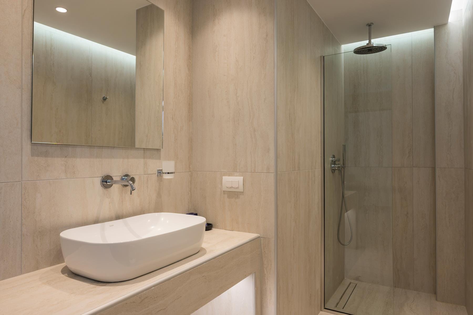 a bathroom with a sink and a shower unit