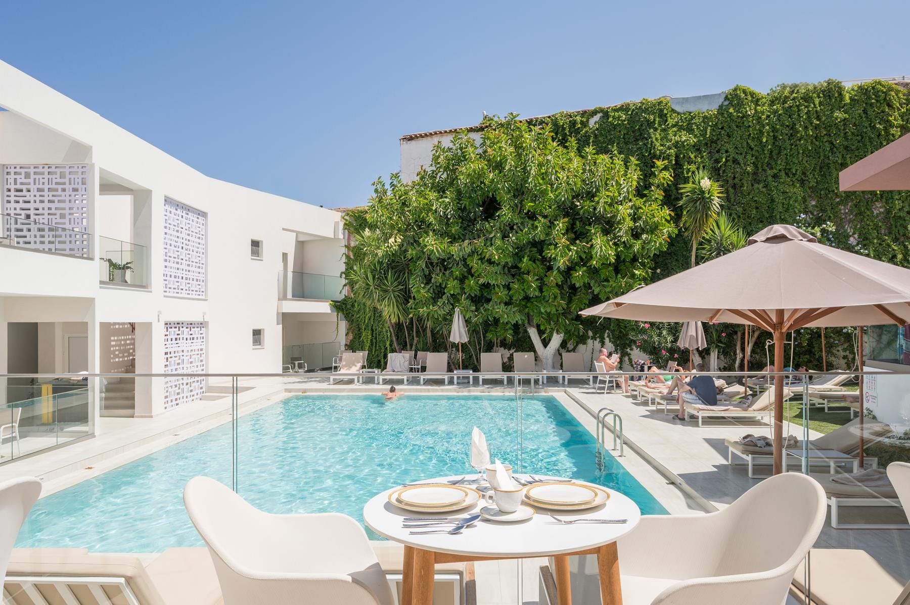 a pool with chairs and umbrellas by it