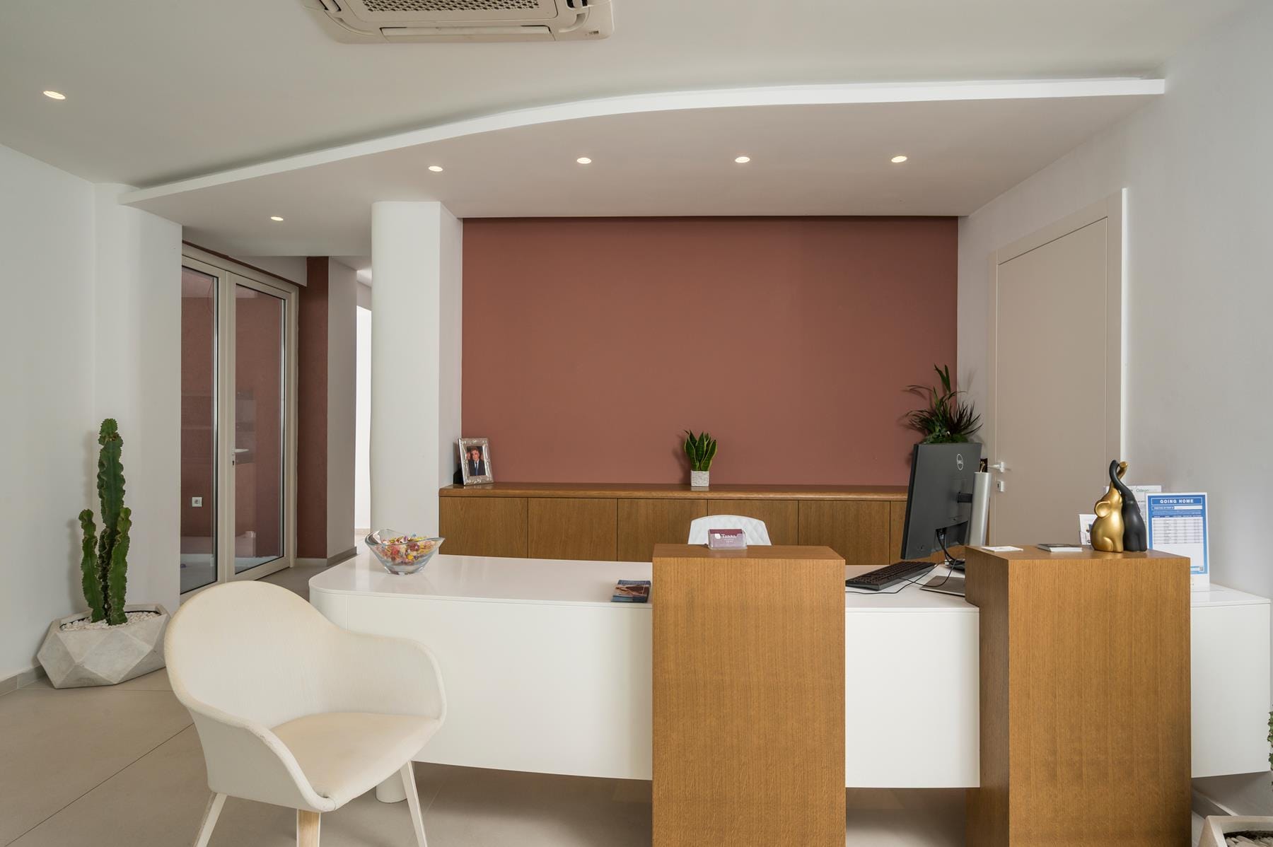 a room with a desk and chairs