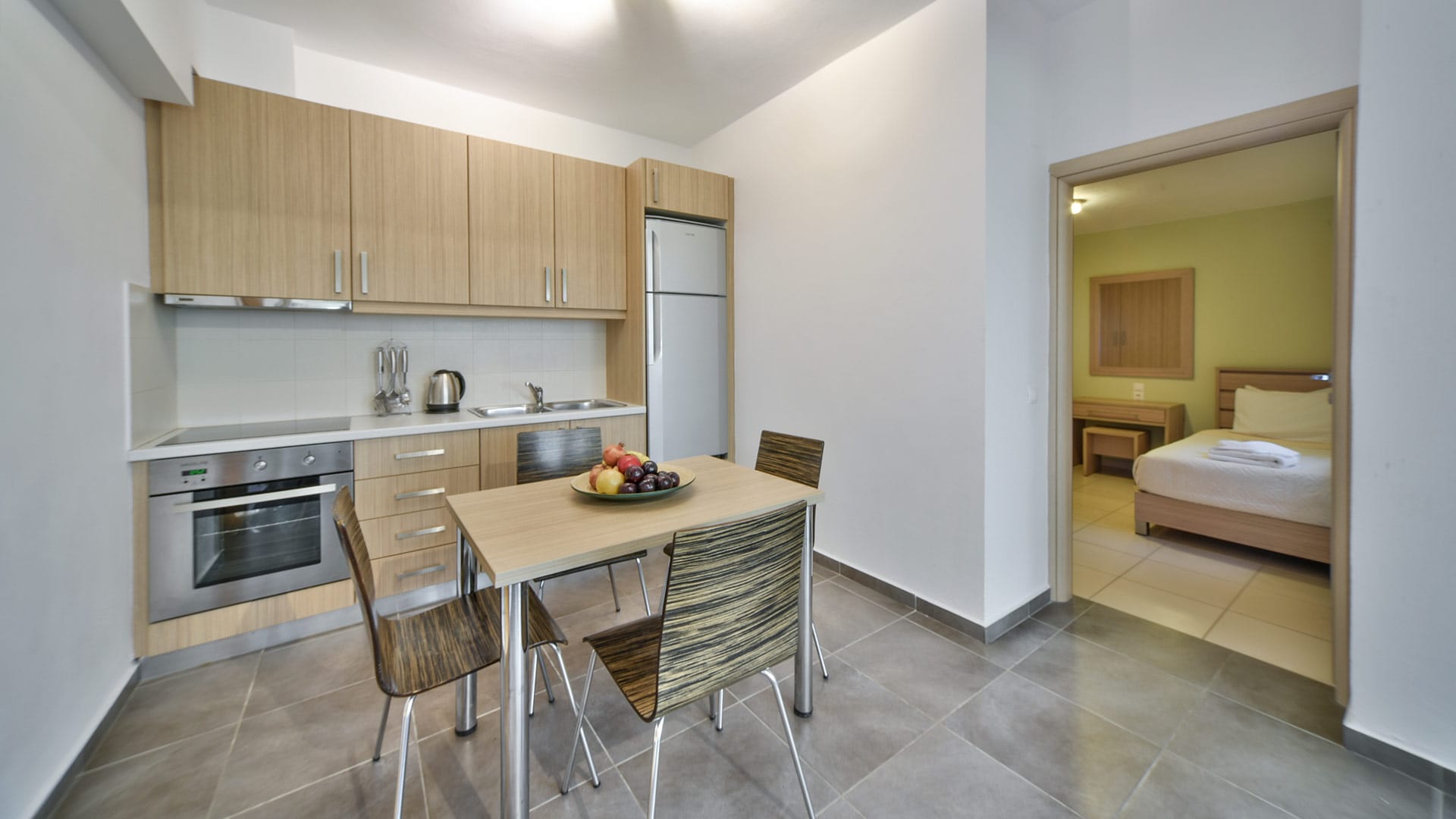 a kitchen with a table and chairs