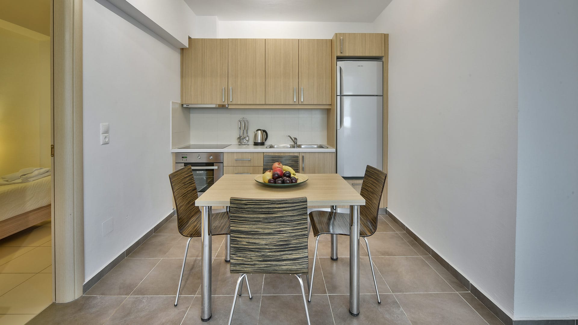 a kitchen with a table and chairs
