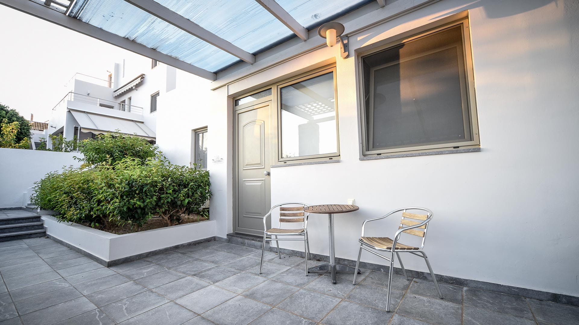 a patio with chairs and a table