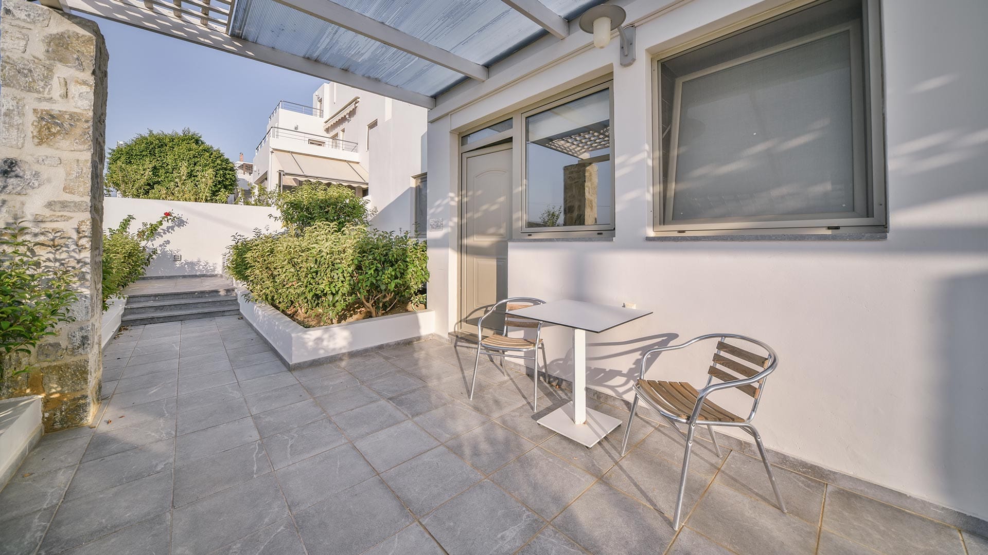 a patio with a table and chairs