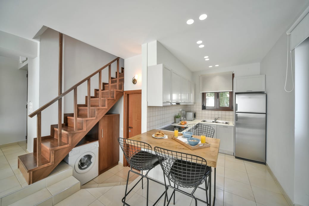 a kitchen with a table and chairs