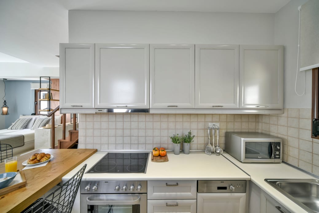 a kitchen with white cabinets