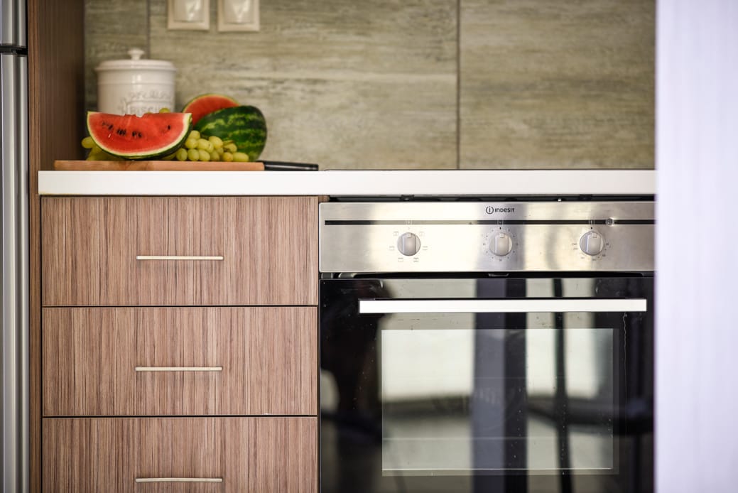 a kitchen with a stove and a counter top with food on it