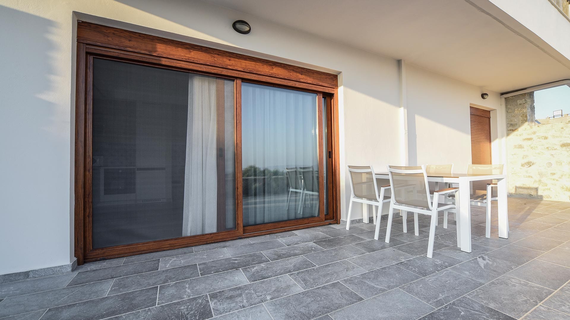 a room with a table chairs and a window