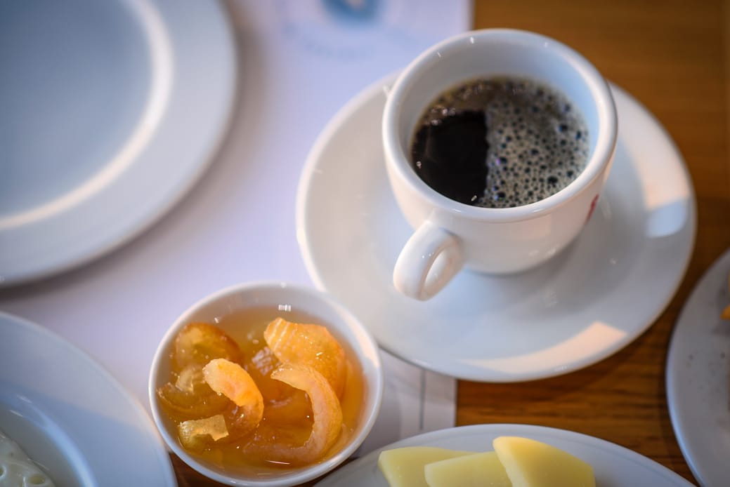 a cup of coffee and a couple of cups of coffee on a table