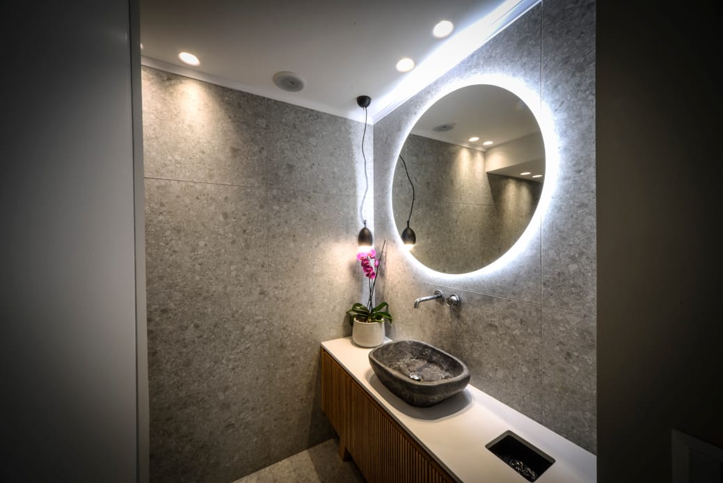 a bathroom with a round mirror