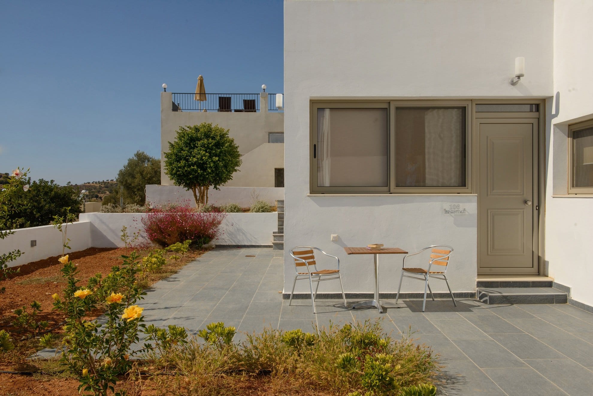 a patio with a table and chairs