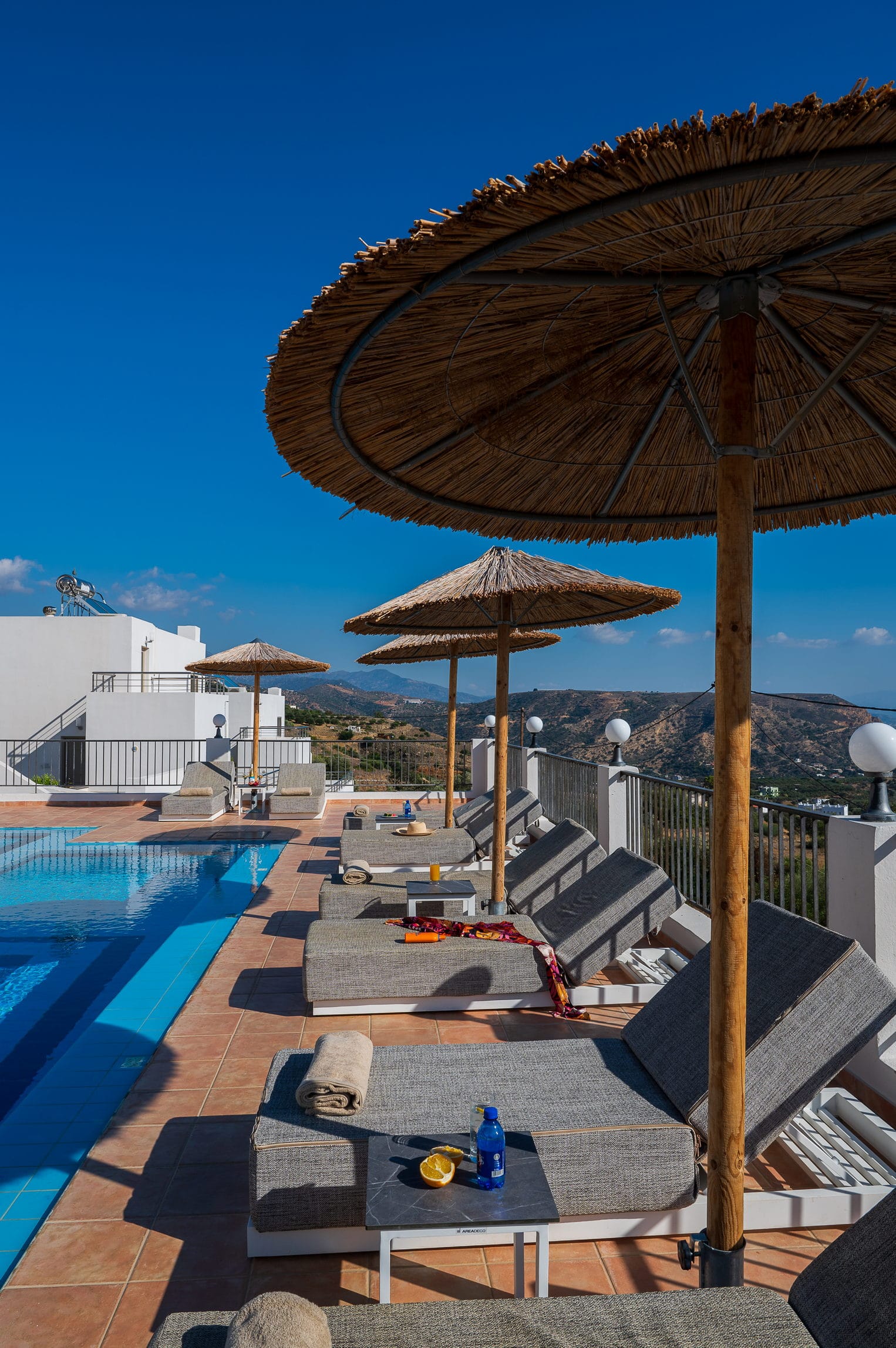 a pool with umbrellas and chairs by it