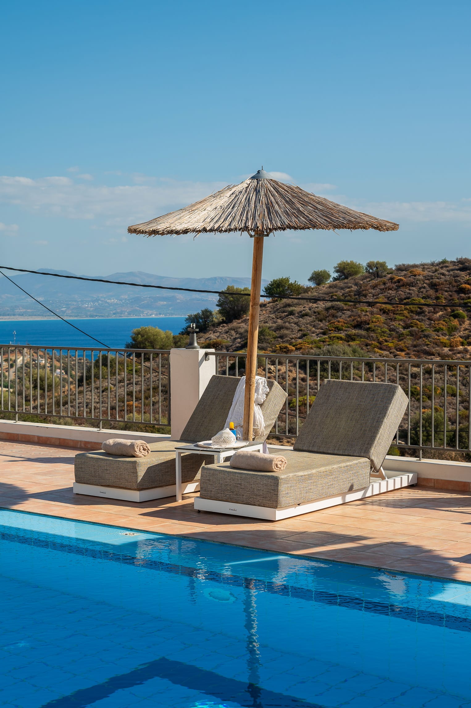 a pool with chairs and umbrella