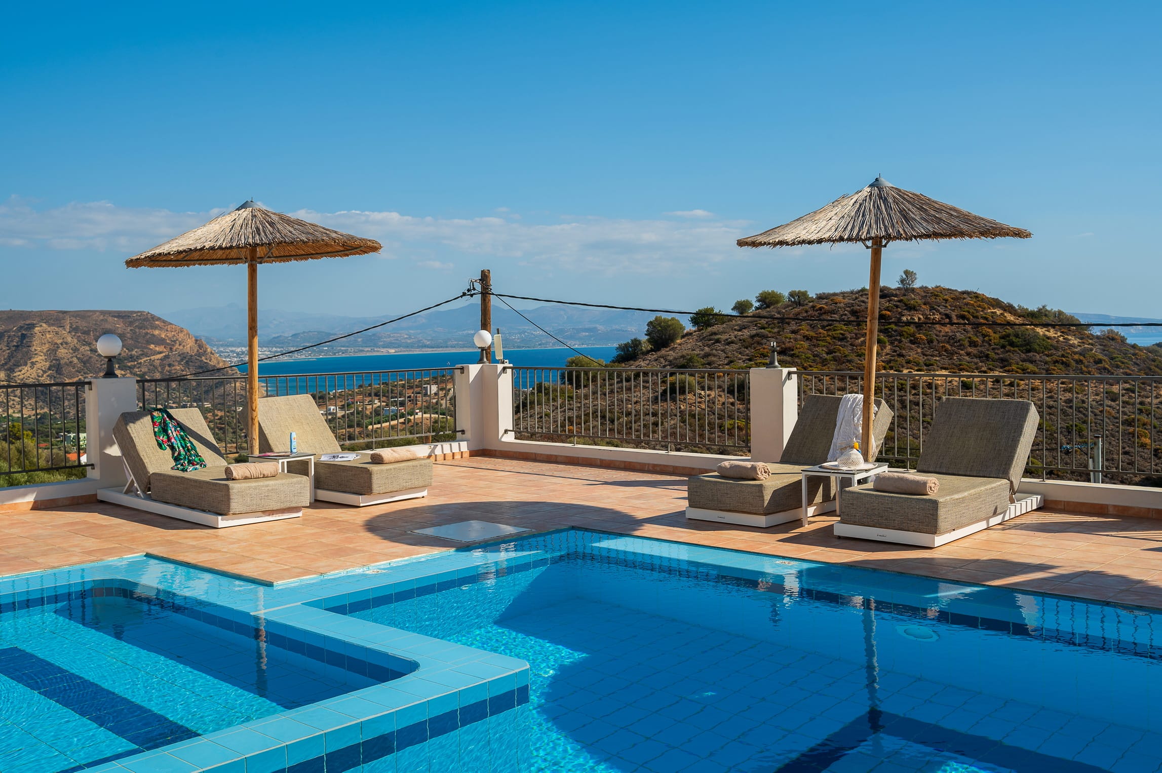 a pool with umbrellas and chairs