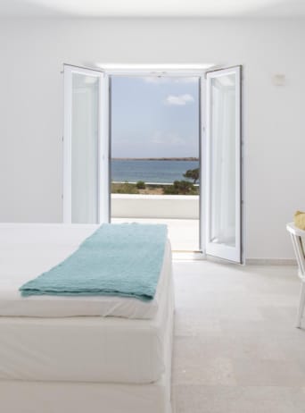 a bedroom with a bed and a chair