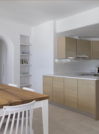 a kitchen with a table and chairs