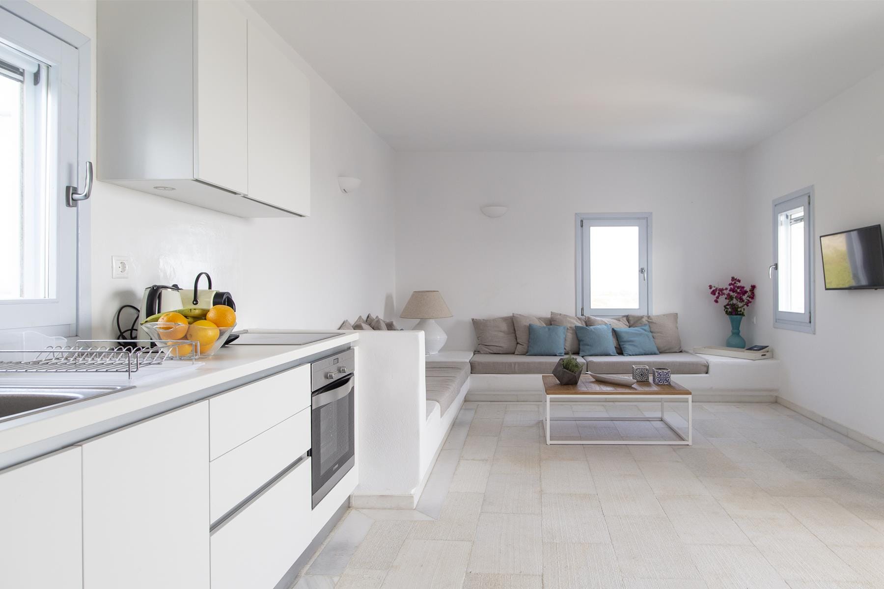a living room with white cabinets