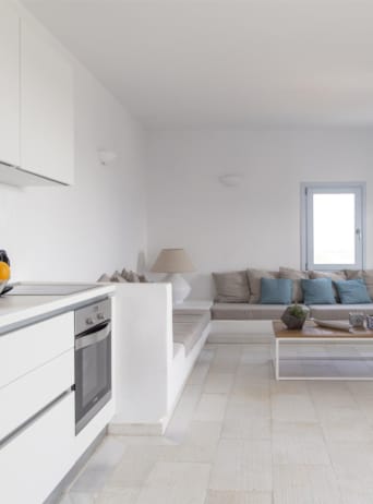 a living room with white cabinets